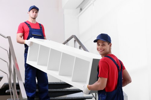 Removal team planning a move in West Hampstead with packed boxes and furniture